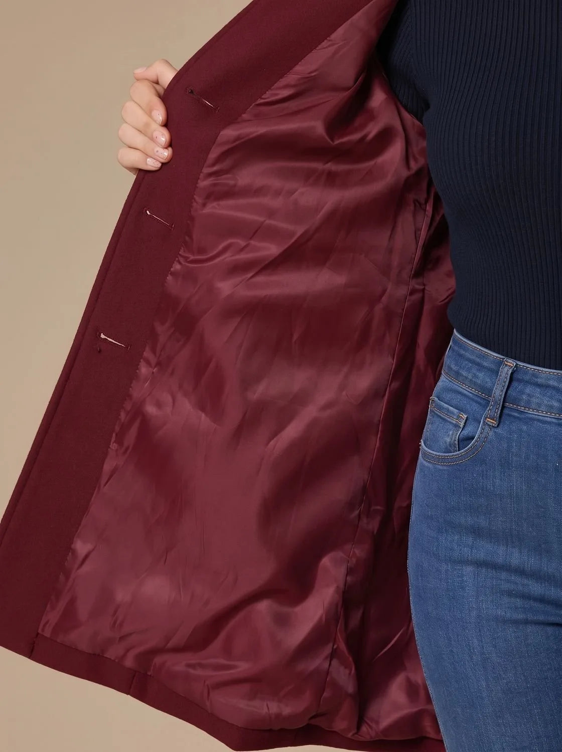 Full-length side profile of the wool coat highlighting the knee-length hem and fitted sleeves