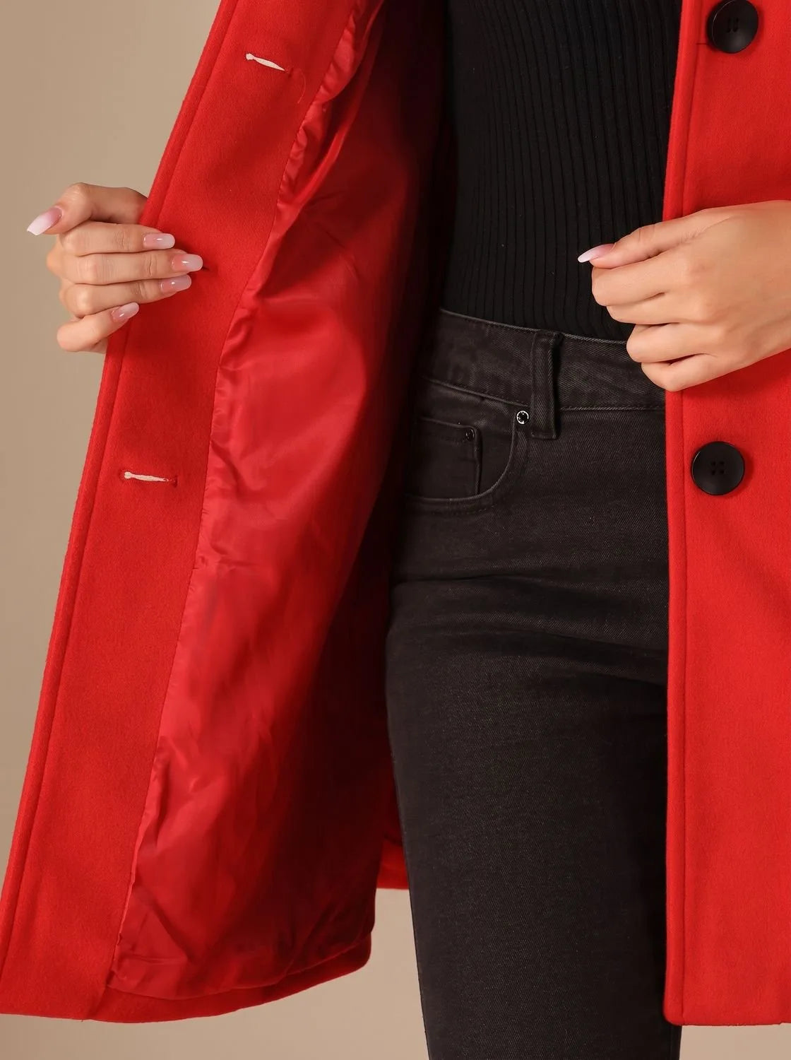 Close-up of coat sleeve and cuff showing the wool fabric texture and clean stitched seam