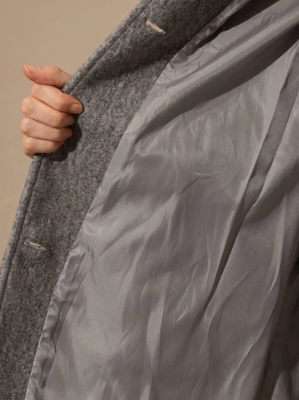 Back view of the A-line wool coat showing the smooth fit across the shoulders and flared skirt