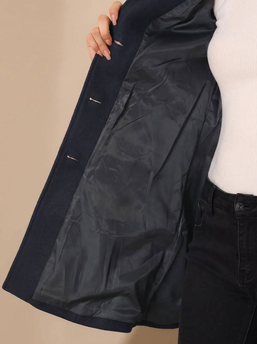 Side angle of burgundy wool coat showing the tailored waist shaping and flared skirt of the A-line hem