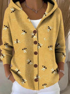 Mustard yellow hooded cardigan with an all-over bee and honeycomb embroidered print