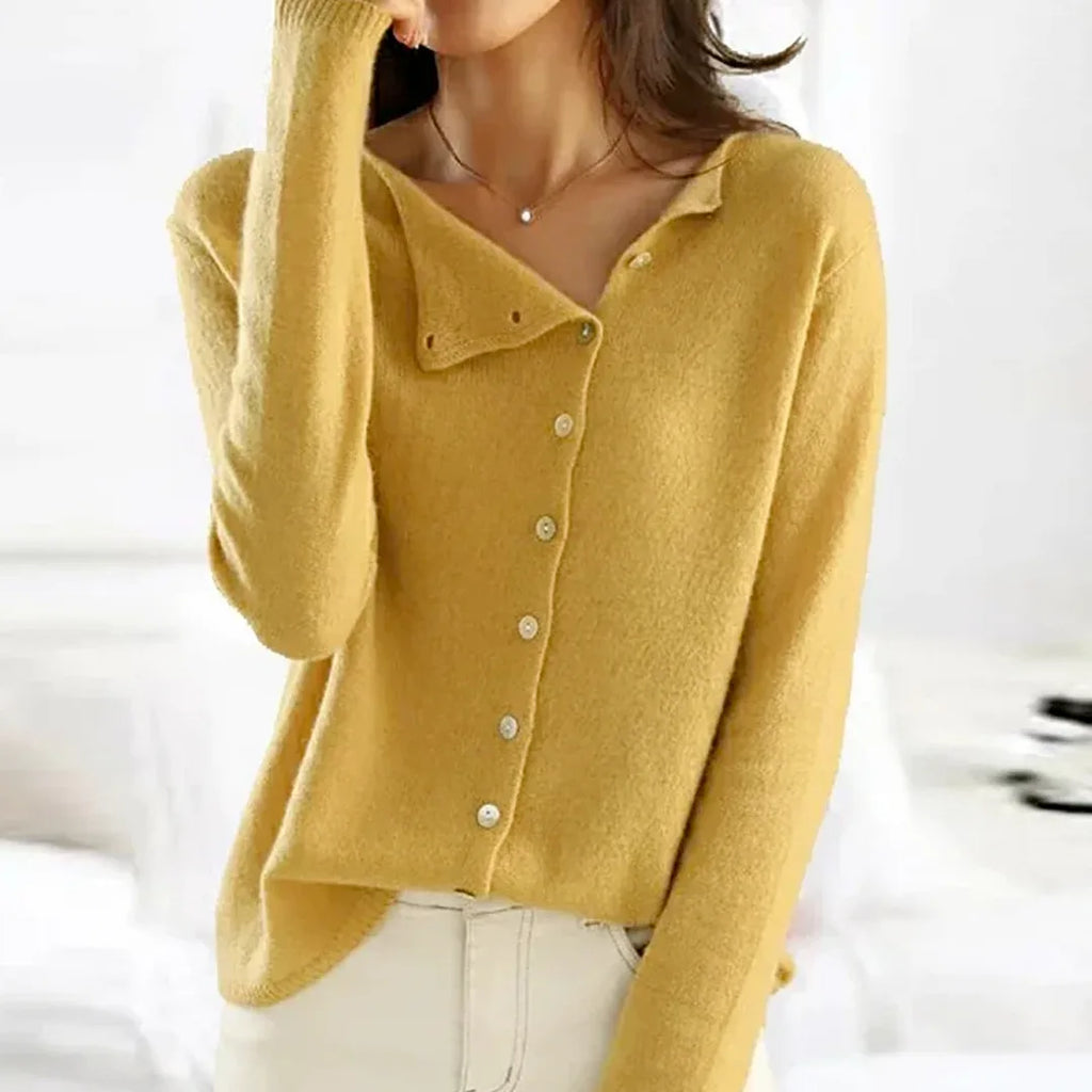Mustard yellow cardigan with folded asymmetric collar shown buttoned to the top