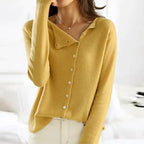 Mustard yellow cardigan with folded asymmetric collar shown buttoned to the top