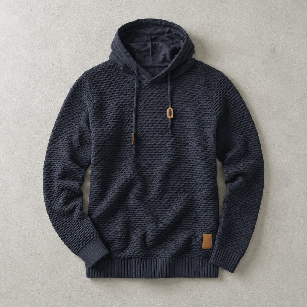 Navy basket-weave pullover hoodie laid flat, showing textured knit, lined hood and tan drawstring toggles