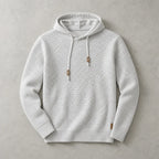 Light grey marl knit pullover hoodie laid flat, showing the woven texture and matching drawstrings