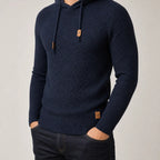 Close-up of a man wearing the navy textured knit hoodie, hands in pockets, showing fit and drawstring detail