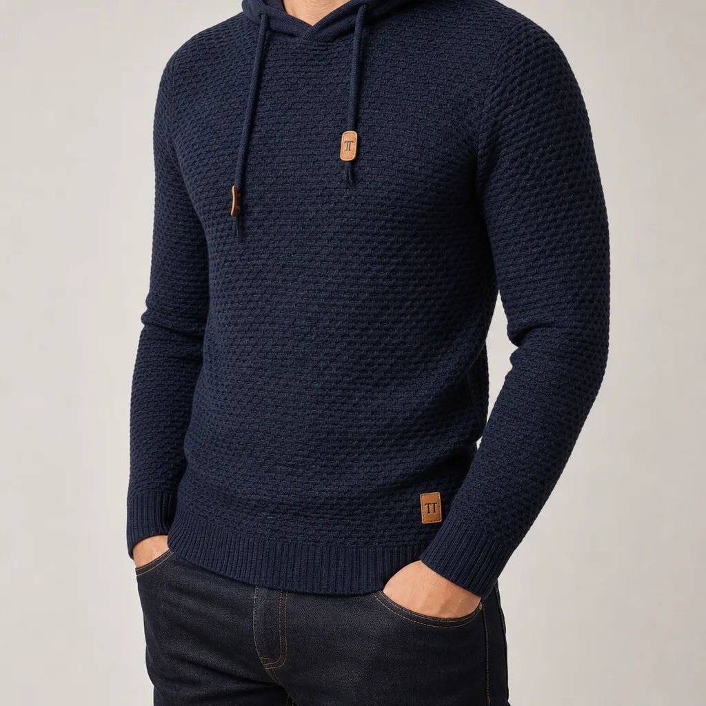 Close-up of a man wearing the navy textured knit hoodie, hands in pockets, showing fit and drawstring detail