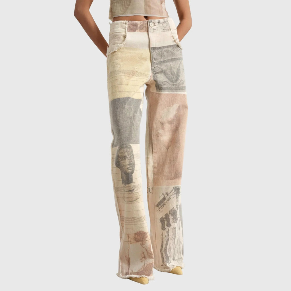 Front view of beige wide-leg jeans with patchwork print of classical statues and sketches, worn with a matching cropped top