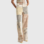 Front view of beige wide-leg jeans with patchwork print of classical statues and sketches, worn with a matching cropped top