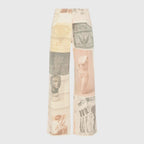 Flat lay front view of the wide-leg jeans showing the full patchwork print from waist to frayed hem