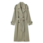 Light green longline trench coat with tie belt and dropped shoulders, front view on model