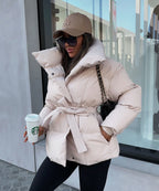 Side angle of the cream belted puffer jacket showing the oversized collar and tied waist belt
