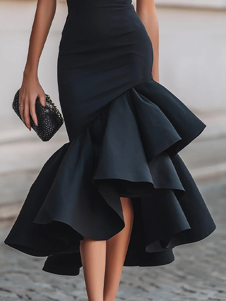 Detail shot of the asymmetric layered ruffle hem showing the flared, cascading skirt fabric