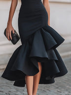 Detail shot of the asymmetric layered ruffle hem showing the flared, cascading skirt fabric
