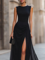 Close-up of the ruched bodice and cinched waist detail on the black sleeveless evening dress.