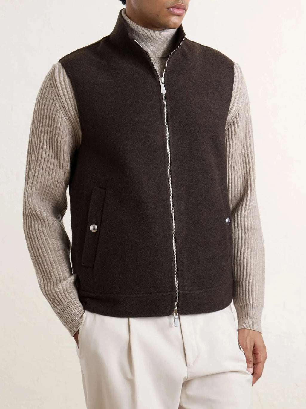 Front view of man wearing a brown brushed-wool zip-up gilet over a grey ribbed polo neck jumper