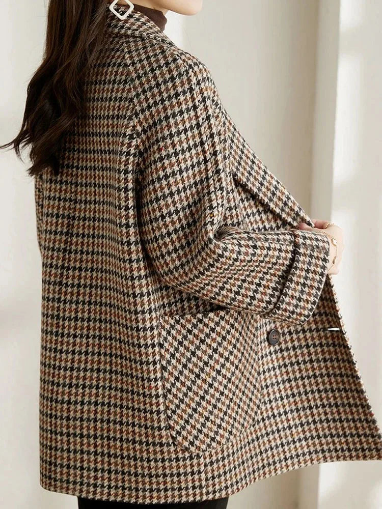 Back view of the brown checked blazer showing the relaxed silhouette and wide sleeve cuffs