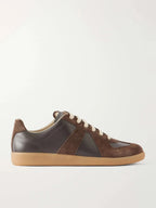 Side profile of brown leather and suede trainer with cream laces and gum sole