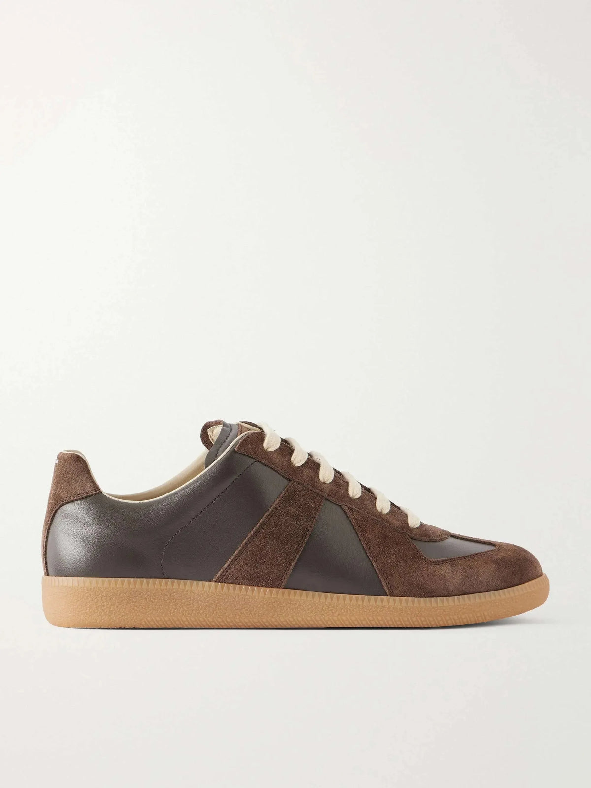 Side profile of brown leather and suede trainer with cream laces and gum sole