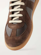 Close-up of the toe panel showing suede and smooth leather paneling with cream laces