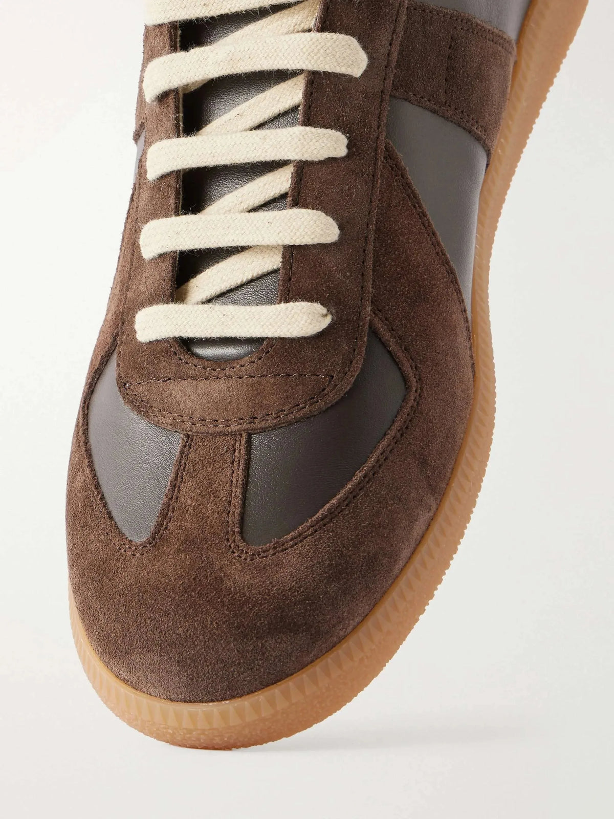 Close-up of the toe panel showing suede and smooth leather paneling with cream laces