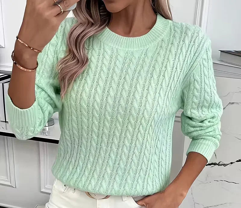 Side angle of the jumper showing the raglan sleeve construction and ribbed cuff