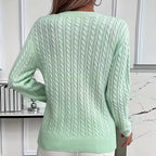 Front view highlighting the relaxed, easy fit of the jumper against white trousers