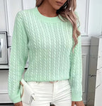 Close-up of the ribbed hem finish at the base of the cable-knit jumper