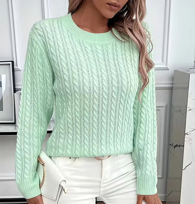 Close-up of the ribbed hem finish at the base of the cable-knit jumper