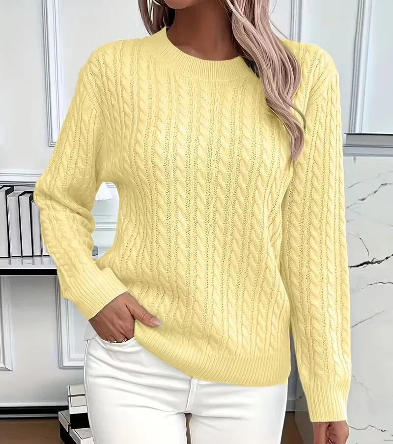 Pale yellow cable-knit jumper with ribbed hem and crew neckline, styled with white trousers