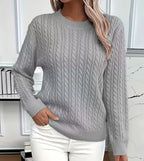 Light grey cable-knit jumper with ribbed hem, paired with white trousers