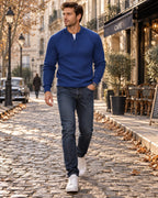 Cobalt blue cable-knit Henley jumper with ribbed cuffs and hem, styled with dark denim and white high-top trainers.