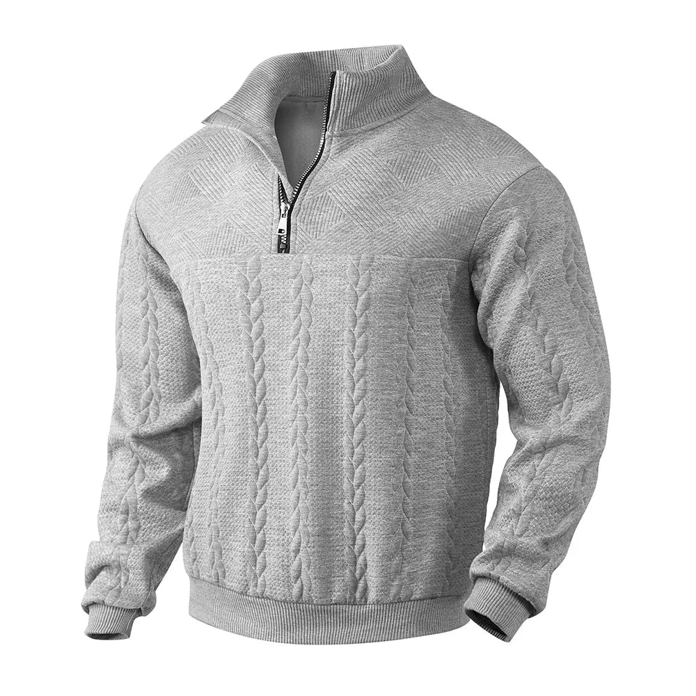Close-up front view of beige cable-knit jumper showing zip pull, ribbed cuffs and hem detail