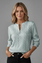 Front view of a pale sage green marl cable knit jumper with a short front zip and small collar