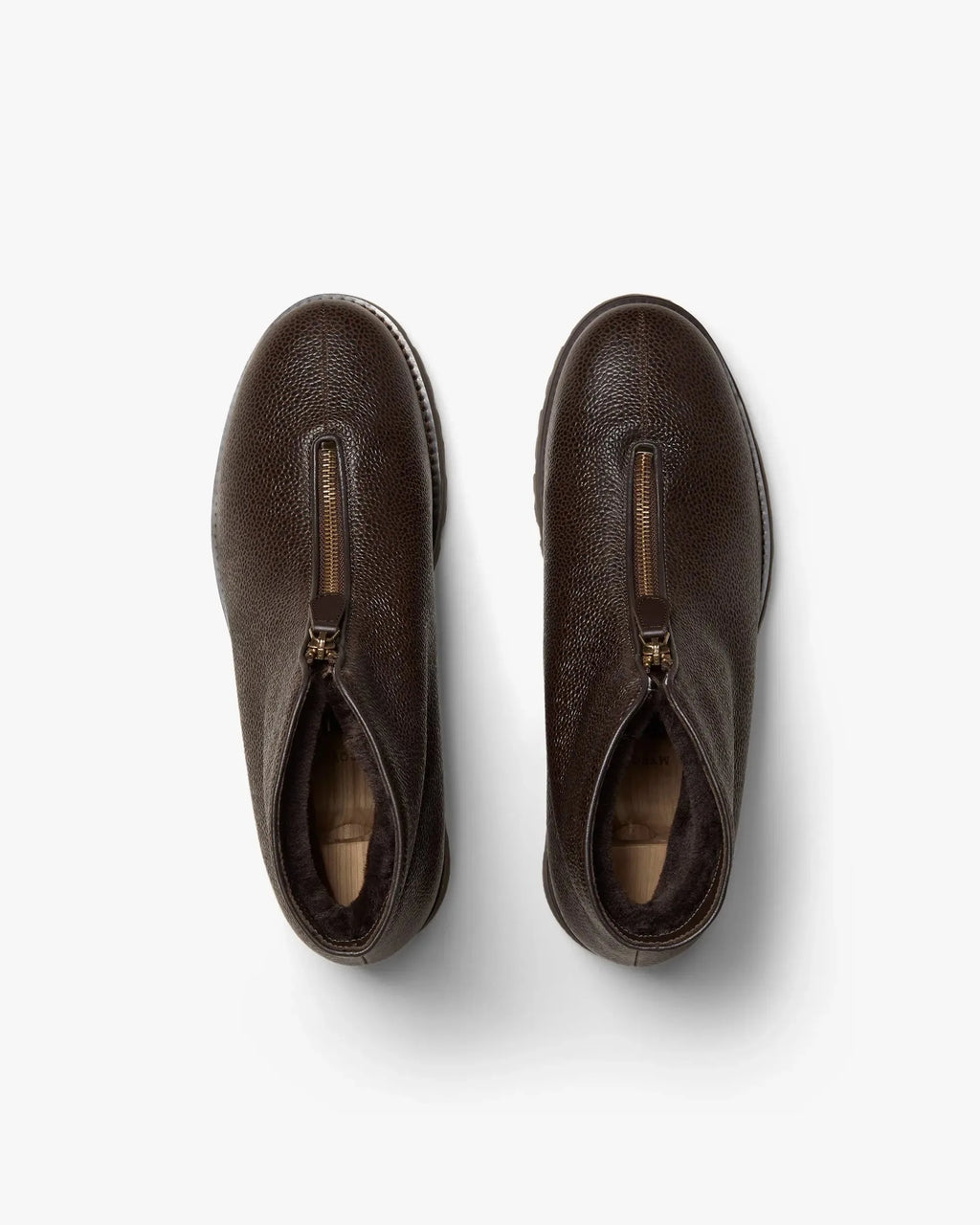 Top-down view of both boots showing the front zip opening and soft dark lining inside