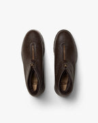 Top-down view of both boots showing the front zip opening and soft dark lining inside