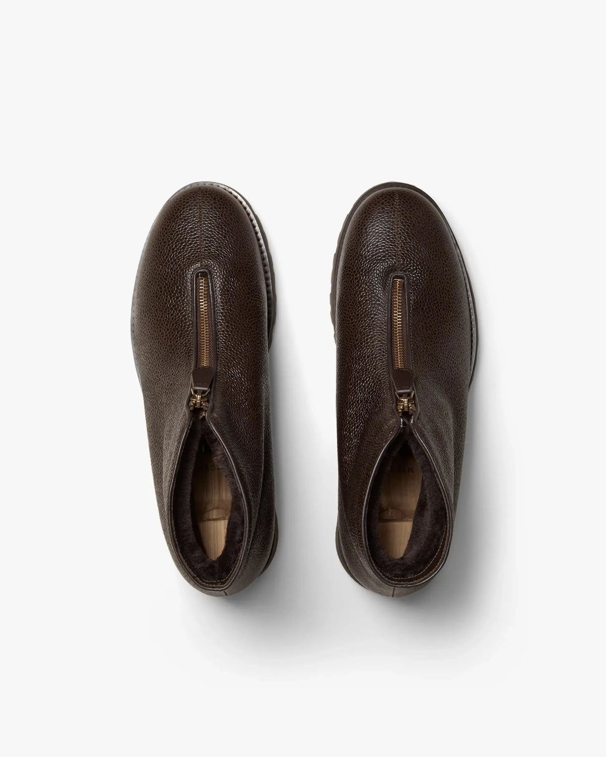 Top-down view of both boots showing the front zip opening and soft dark lining inside