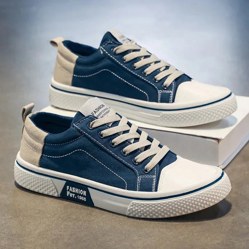 Side profile of blue canvas trainers showing the white rubber sole and FASHION heel logo