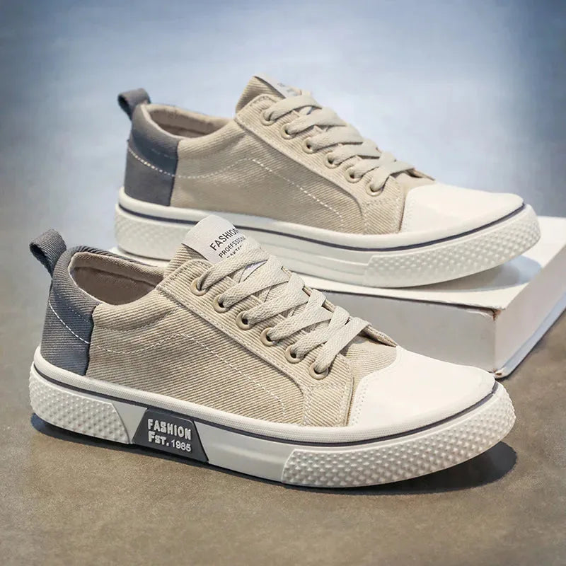 Side profile of beige canvas trainers with navy heel accent and chunky white sole