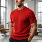 Front view of a bold red short-sleeve knitted T-shirt with ribbed hem, worn in a bright indoor loft setting