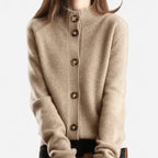 Front view of a camel cashmere cardigan with a ribbed stand collar and wooden button placket