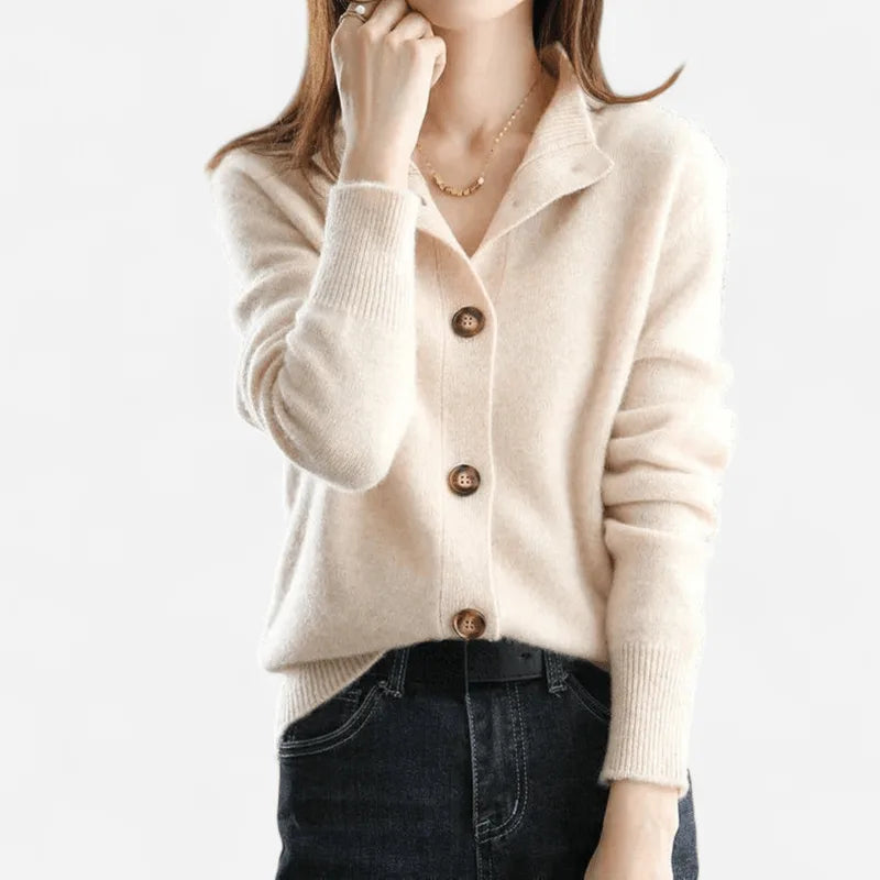 Cream-coloured cashmere cardigan with notched lapel collar worn open over a dark denim skirt