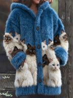 Blue faux fur hooded cardigan with cat print design on sleeves and front, seen from the front