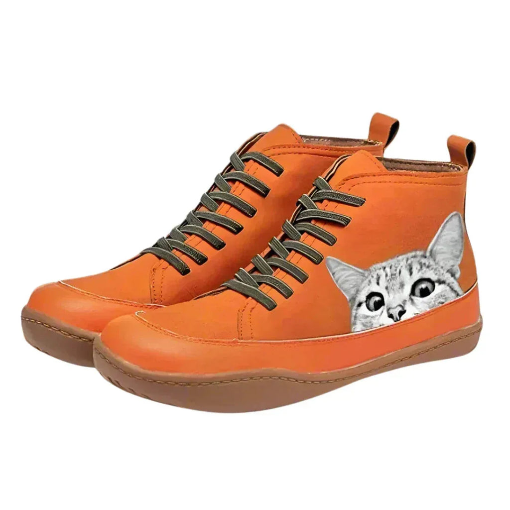 Orange high-top leather boots with a hand-painted grey tabby cat peeking design and olive laces, angled front view