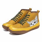 Mustard yellow high-top boots with a peeking cat print on the heel and khaki green laces, side profile