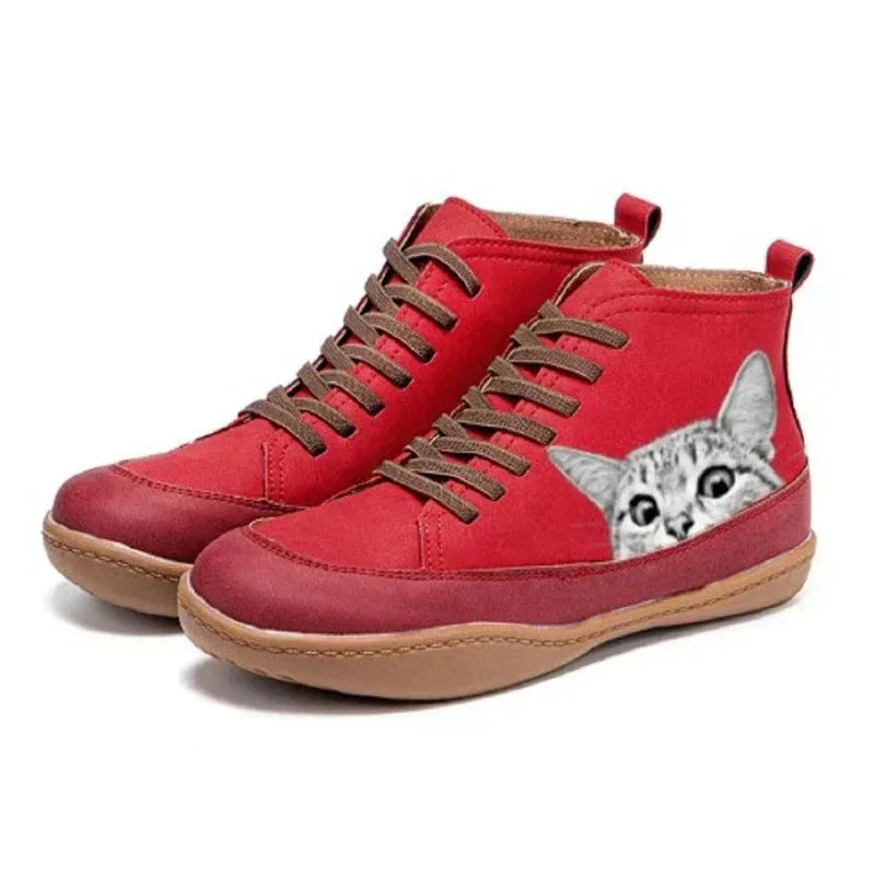 Red high-top boots with a peeking tabby cat graphic on the heel and brown laces, front angled view