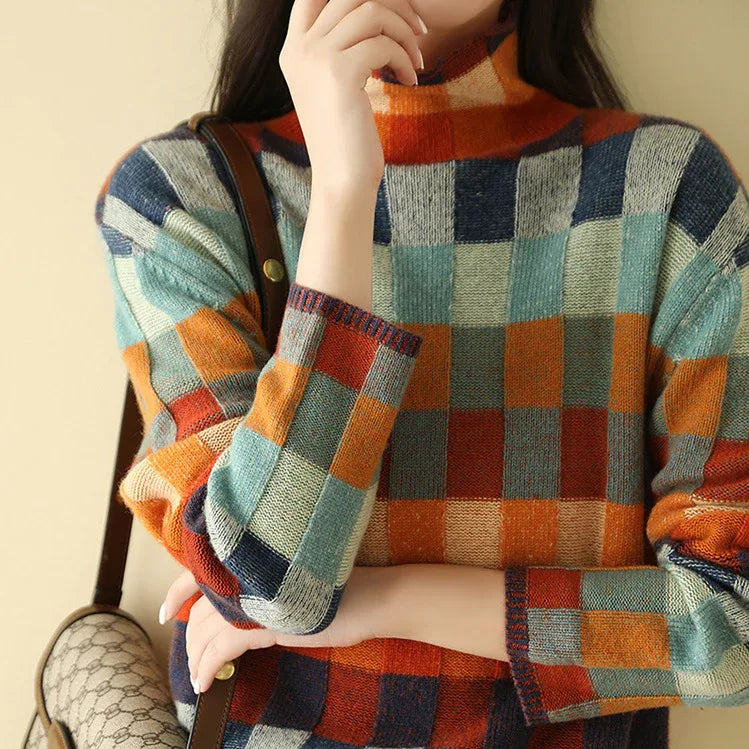 Close-up of the multicolour checked jumper showing the ribbed high neck and slouchy shoulder fit