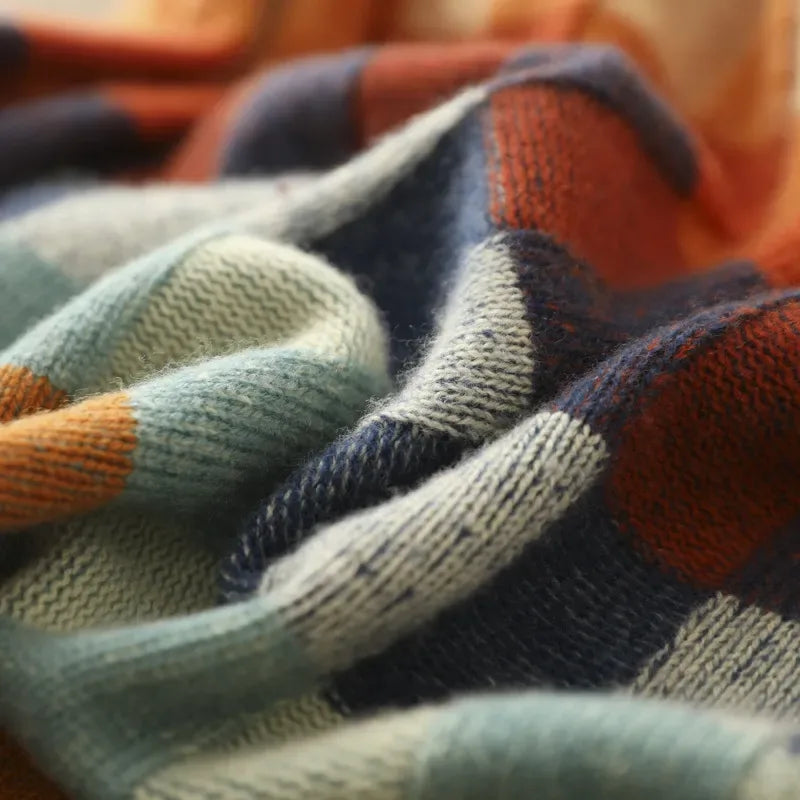Macro shot of the soft knit fabric showing the orange, teal, navy and cream check pattern texture
