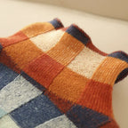 Close-up of the ribbed cuff detail with a contrast navy trim along the edge of the knit sweater