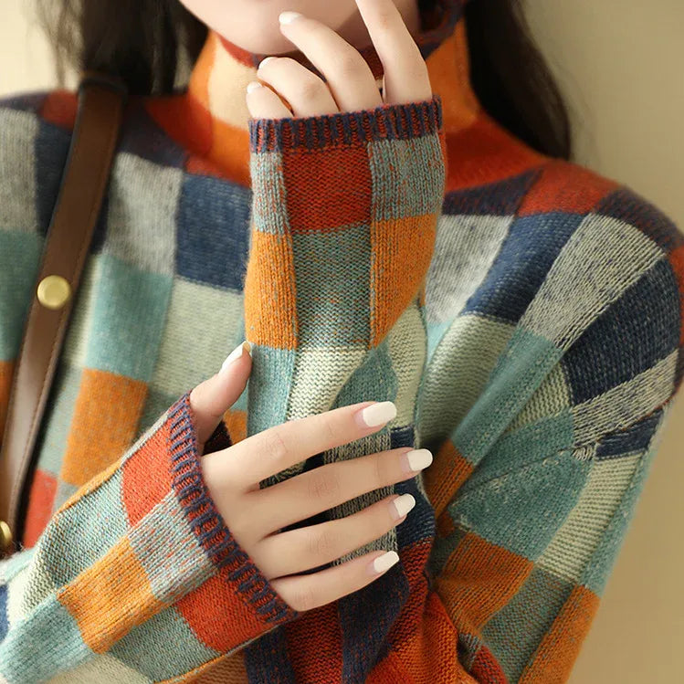 Detail of the high polo neck collar and cuff showing the dense knit and check colour blocks